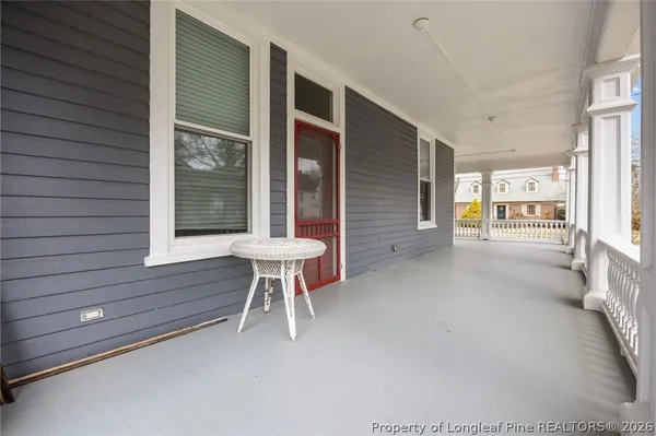 a backyard of a house with table and chairs