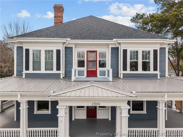 a view of a white house with large windows