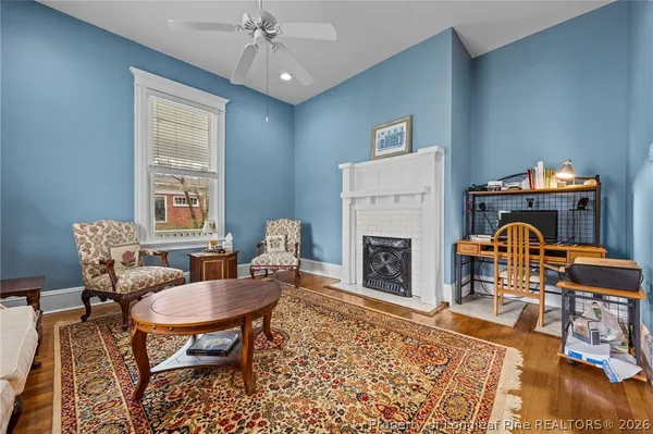 a living room with furniture a fireplace and a table