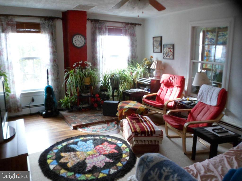 16712 Piney Point Road Piney Point, MD 20674 - Photo 22 of 29 a living room with furniture and a potted plant