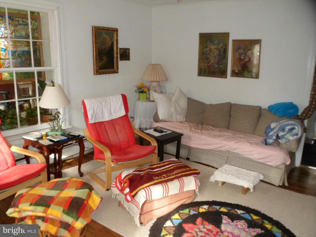 16712 Piney Point Road Piney Point, MD 20674 - Photo 23 of 29 a living room with furniture and a lamp