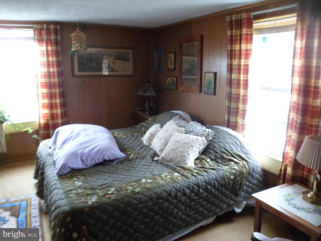 16712 Piney Point Road Piney Point, MD 20674 - Photo 26 of 29 a bedroom with a bed and a window