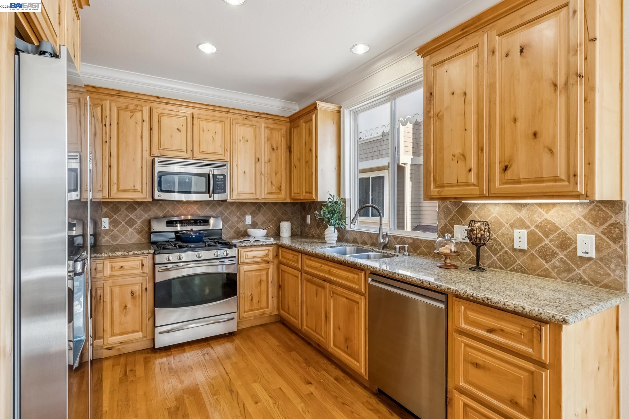 829 Lippert Place Santa Clara, CA 95050 - Photo 13 of 34 a kitchen with stainless steel appliances granite countertop a stove a sink and a microwave