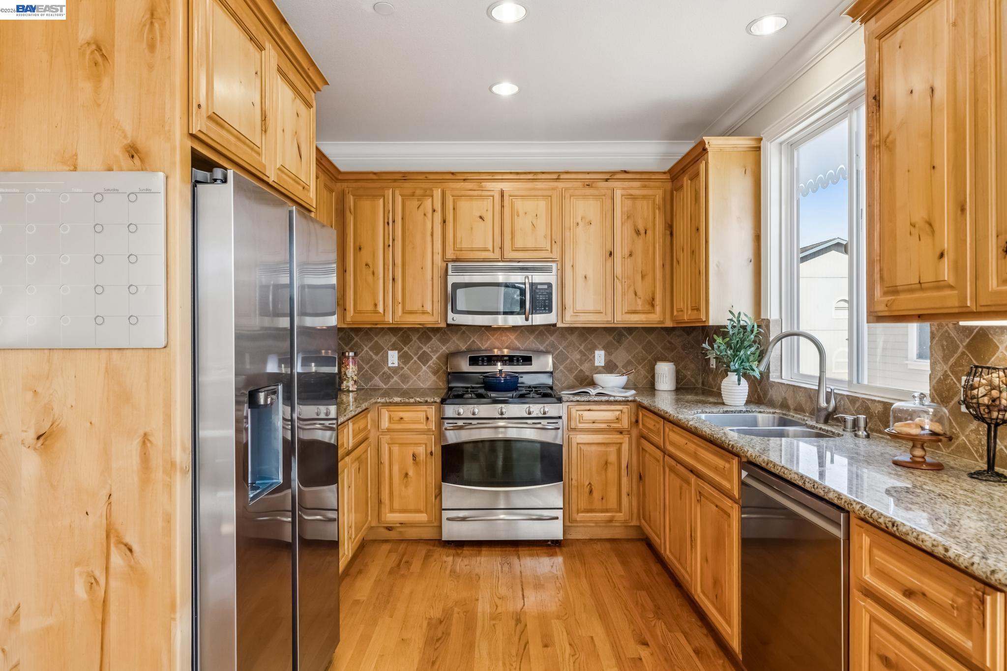 829 Lippert Place Santa Clara, CA 95050 - Photo 14 of 34 a kitchen with stainless steel appliances granite countertop a stove a sink dishwasher and a refrigerator