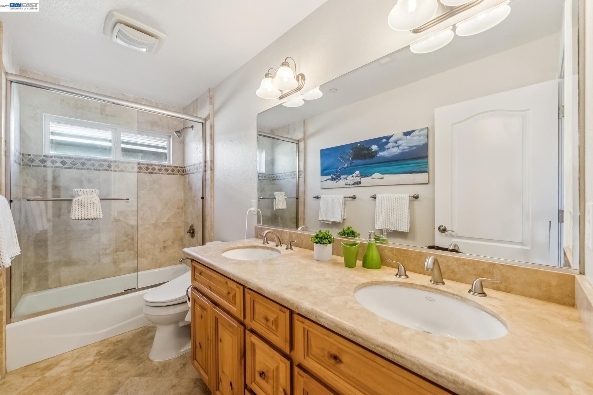 829 Lippert Place Santa Clara, CA 95050 - Photo 28 of 34 a bathroom with a granite countertop sink toilet a large mirror a shower and vanity