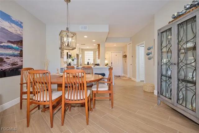 a view of a dining room with furniture and a chandelier