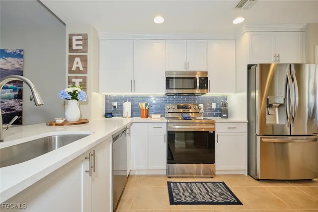 a kitchen with a refrigerator sink and microwave