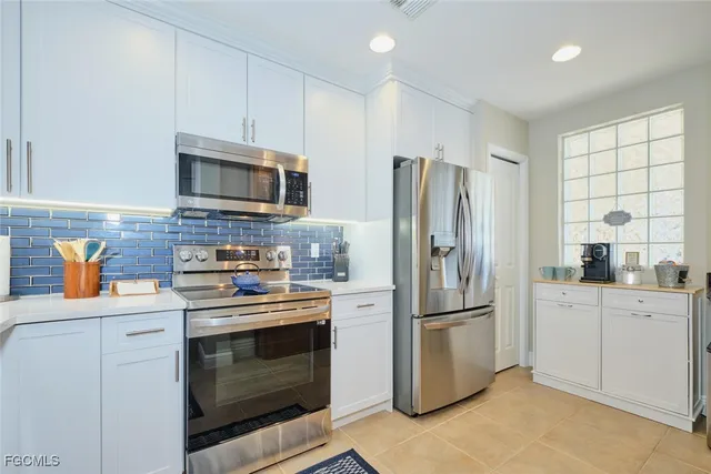a kitchen with stainless steel appliances a stove a refrigerator and a sink