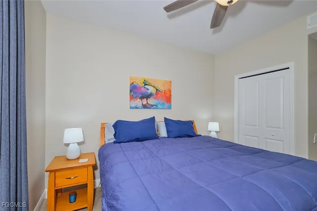 a bedroom with a bed and painting on the wall