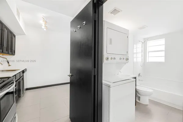 a walk in closet with wooden floor