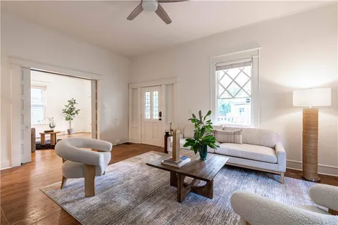 a living room with furniture and a potted plant