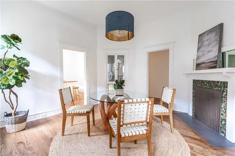 a dining room with furniture a fireplace and a chandelier