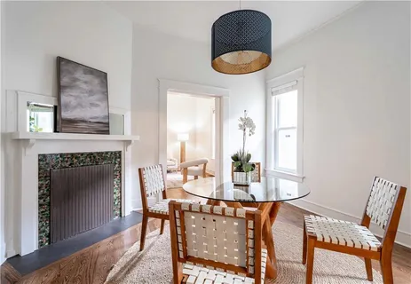 a kitchen with a stove and wooden floor