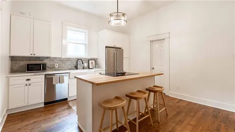 a kitchen with a refrigerator a stove and a refrigerator