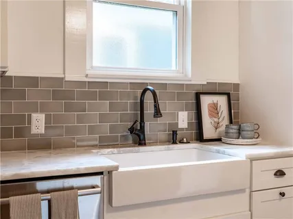a kitchen with a stove a sink and a refrigerator