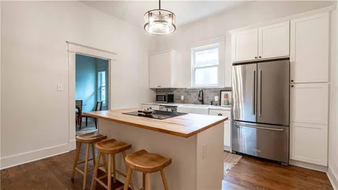 an empty room with wooden floor and a window
