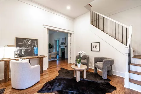 a bedroom with a bed and painting on the wall