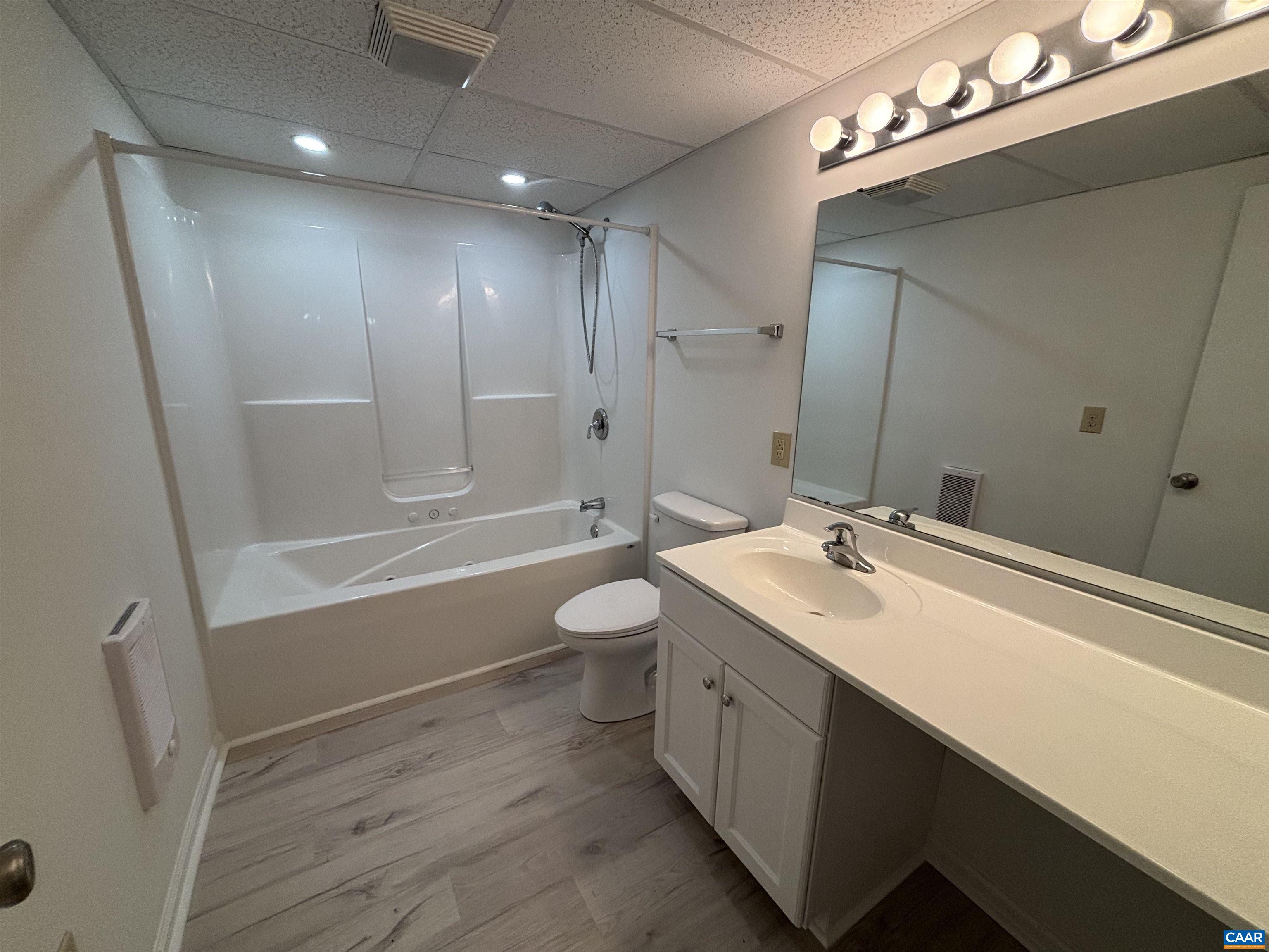 988 Salisbury Square Charlottesville, VA 22901 - Photo 15 of 17 a bathroom with a double vanity sink a toilet a mirror and shower