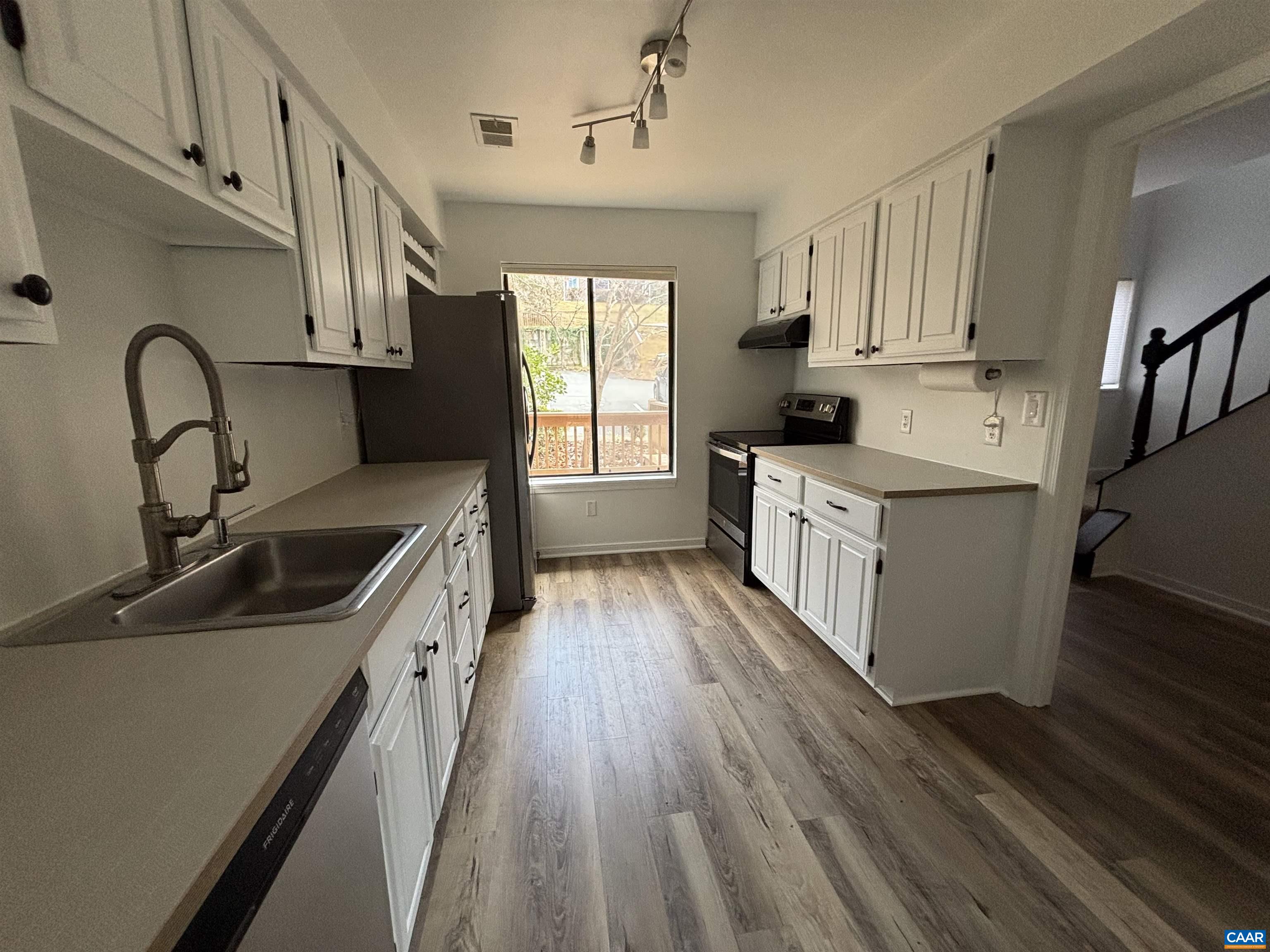 988 Salisbury Square Charlottesville, VA 22901 - Photo 8 of 17 a kitchen with granite countertop a sink and wooden floors