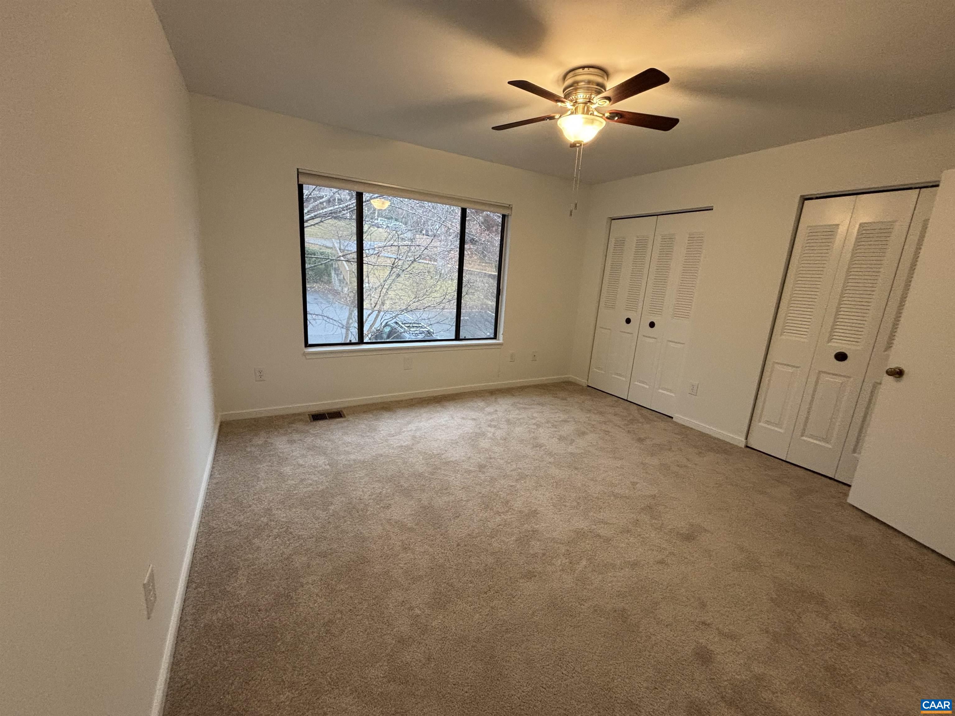 988 Salisbury Square Charlottesville, VA 22901 - Photo 9 of 17 an empty room with windows and fan