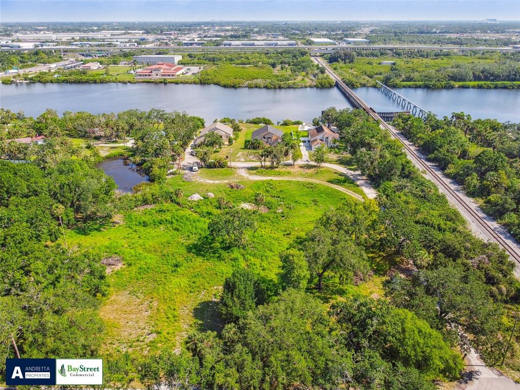 5116 Palm River Road Tampa, FL 33619 - Photo 2 of 10 an aerial view of residential houses with outdoor space and city view