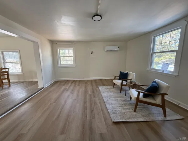 a view of a livingroom with wooden floor and a window
