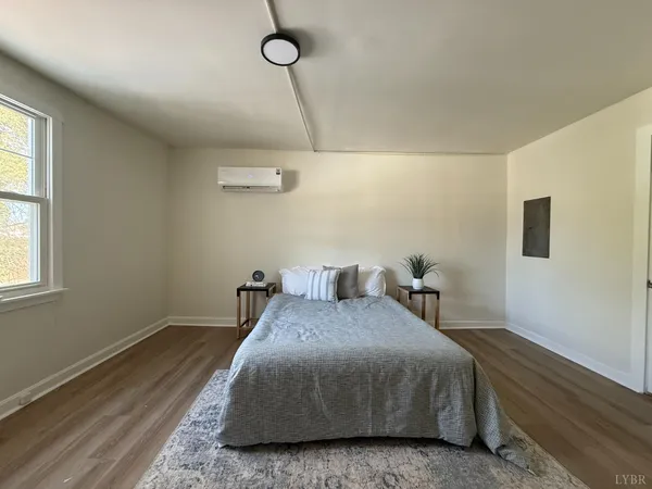 a bedroom with a bed and window