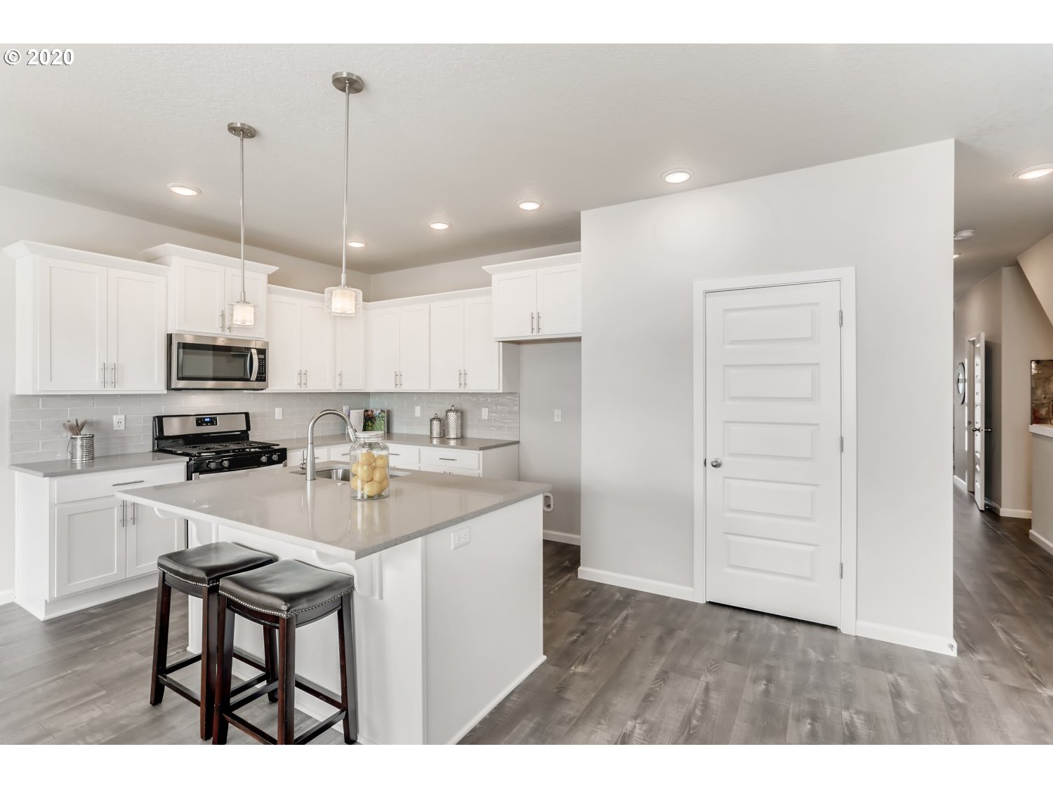 1550 19th Avenue Forest Grove, OR 97116 - Photo 11 of 26 a kitchen with kitchen island white cabinets and stainless steel appliances