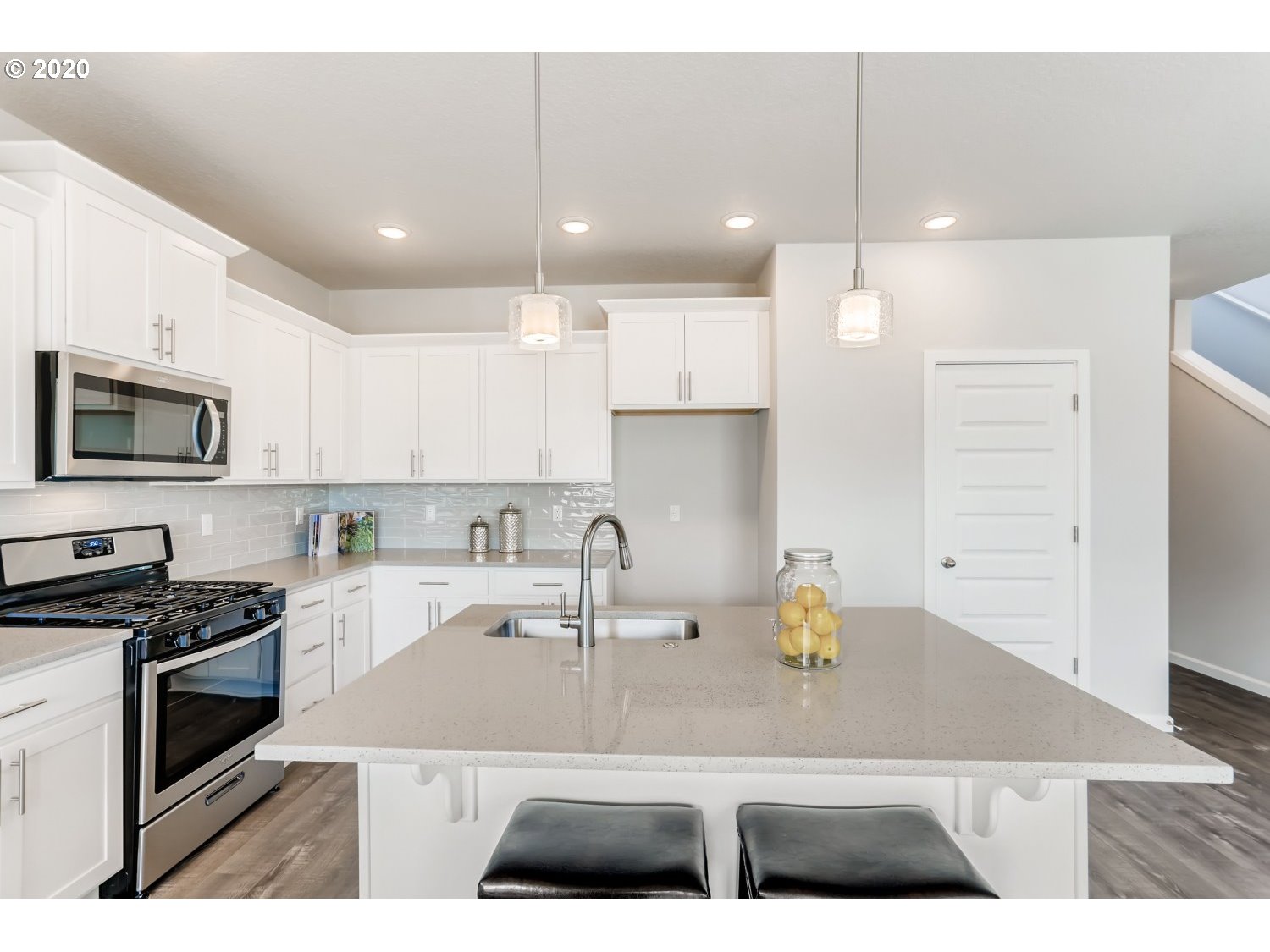 1550 19th Avenue Forest Grove, OR 97116 - Photo 12 of 26 a kitchen with kitchen island granite countertop a sink a counter top space appliances and cabinets