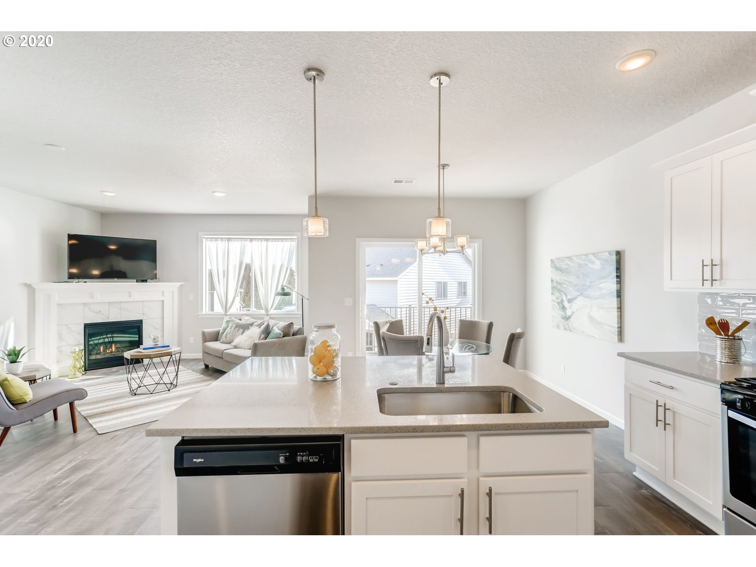 1550 19th Avenue Forest Grove, OR 97116 - Photo 14 of 26 a kitchen with a sink dishwasher a dining table and chairs with wooden floor