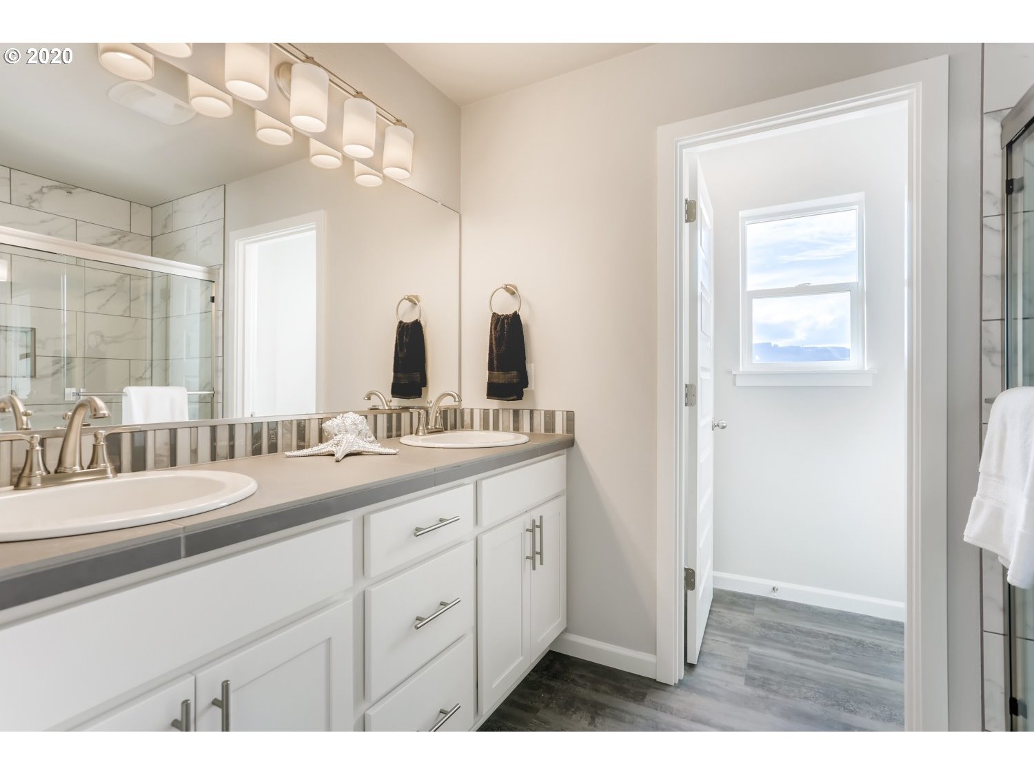 1550 19th Avenue Forest Grove, OR 97116 - Photo 17 of 26 a bathroom with a double vanity sink and a mirror