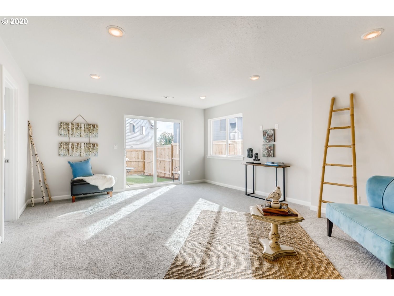 1550 19th Avenue Forest Grove, OR 97116 - Photo 23 of 26 a spacious bedroom with a bed a couch and large window
