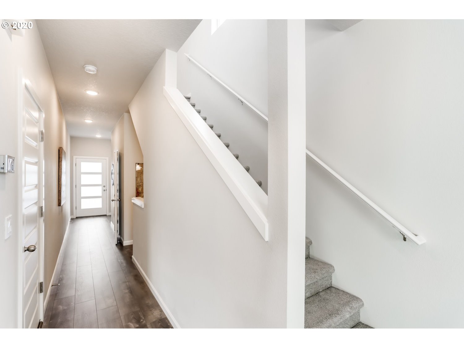 1550 19th Avenue Forest Grove, OR 97116 - Photo 5 of 26 a view of a hallway with wooden floor and staircase