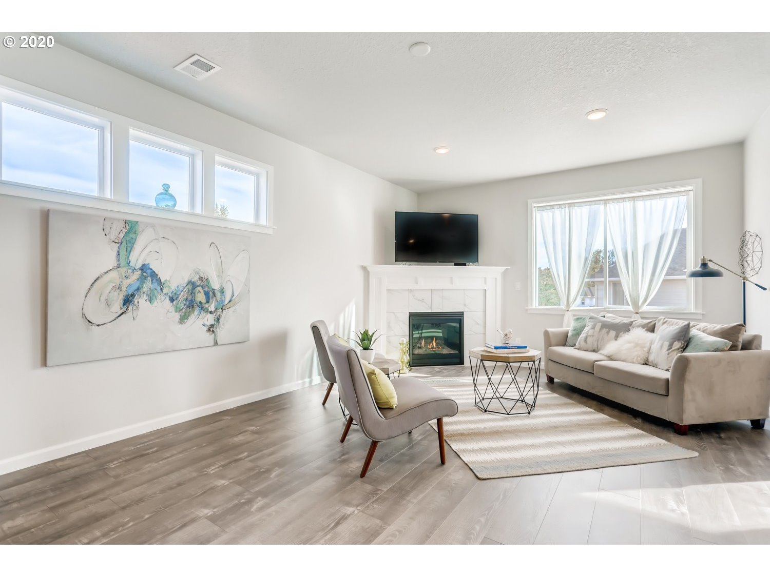 1550 19th Avenue Forest Grove, OR 97116 - Photo 7 of 26 a living room with furniture a fireplace and a flat screen tv
