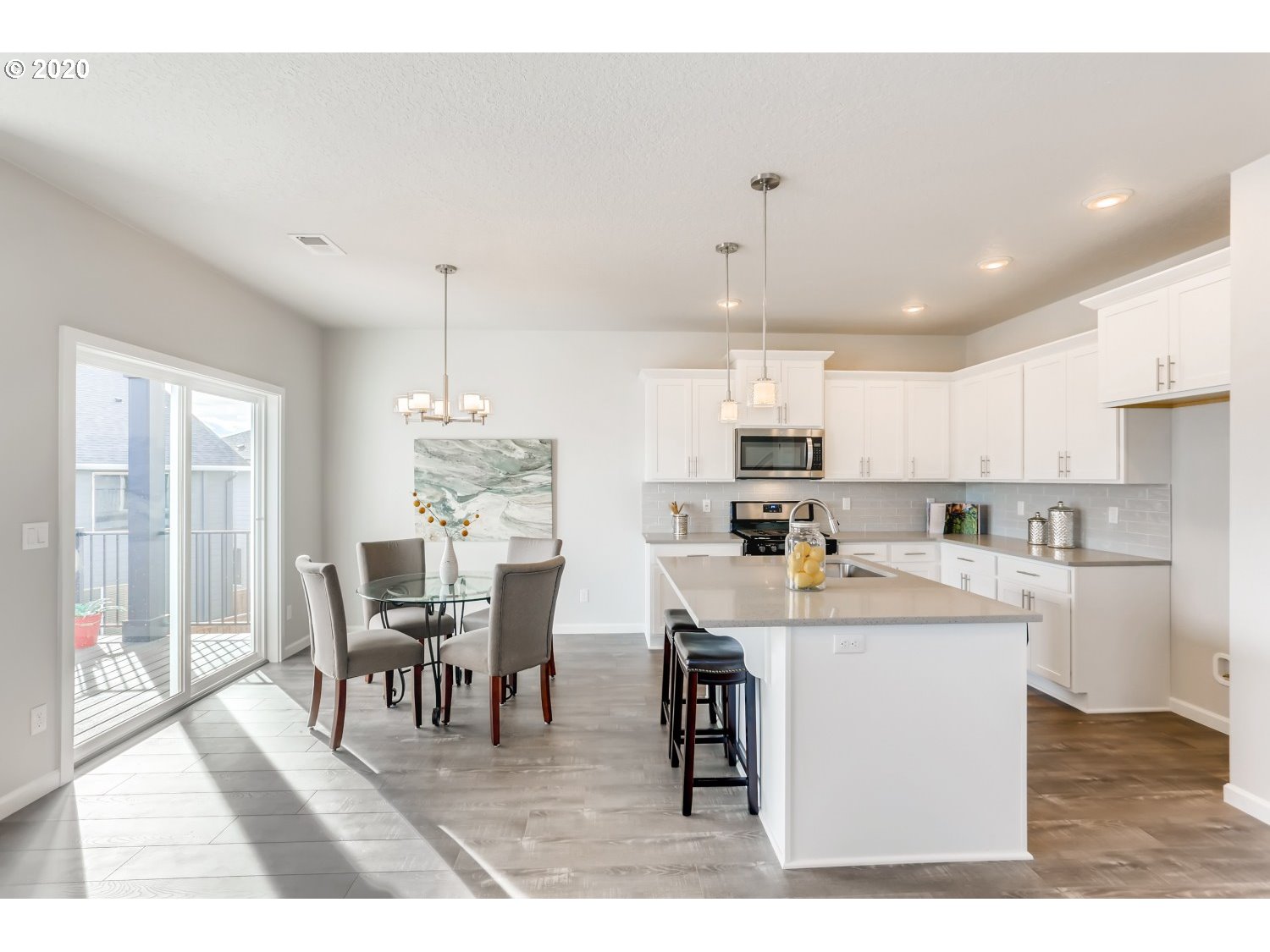 1550 19th Avenue Forest Grove, OR 97116 - Photo 10 of 26 a kitchen with a dining table chairs and white appliances