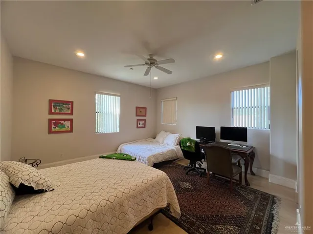 a bedroom with a bed and a desk