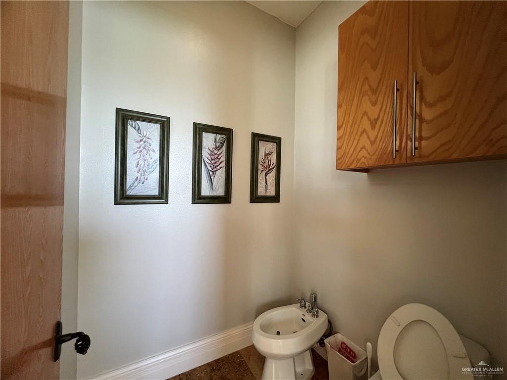 416 Frio Street Mission, TX 78572 - Photo 25 of 35 a bathroom with a toilet and a sink