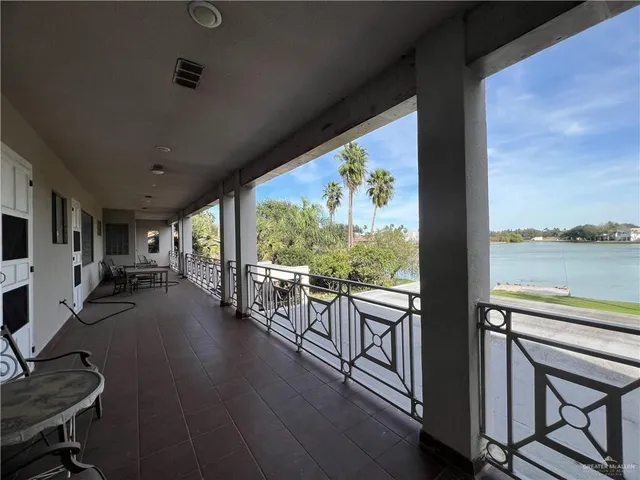 a living room with furniture a flat screen tv and a table
