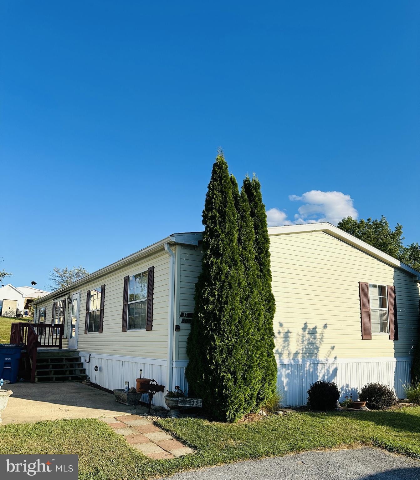 a view of a white house with a yard