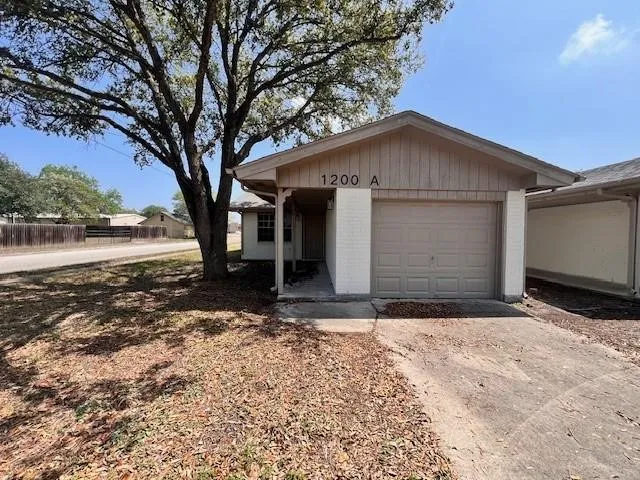 a view of a house with a yard and garage