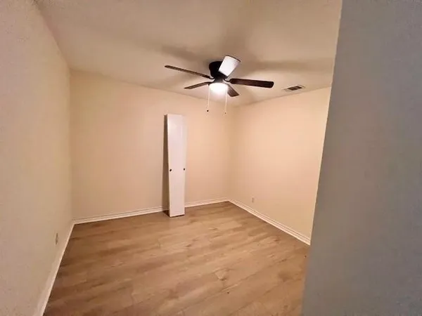 an empty room with a fan