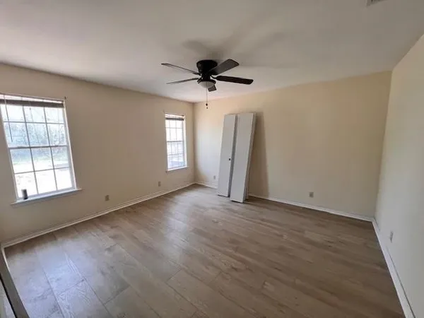wooden floor in an empty room with a window