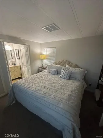 a bedroom with a bed and a mirror