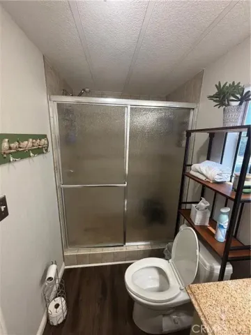 a bathroom with a toilet and a shower