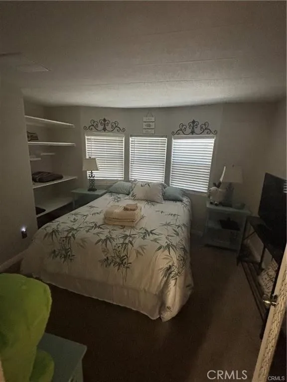 670 Channel Needles, CA 92363 - Photo 9 of 19 a bedroom with a bed and chair