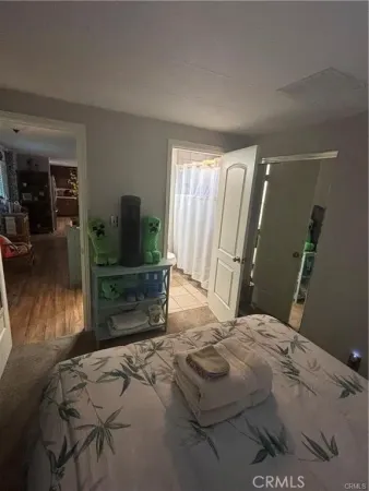 a bedroom with a bed and flat screen tv
