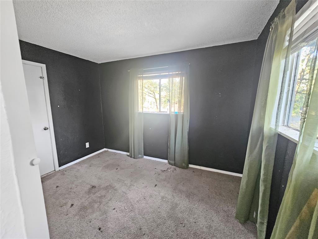 709 Cedarcrest Drive Tool, TX 75143 - Photo 14 of 15 a view of a room with windows and closet