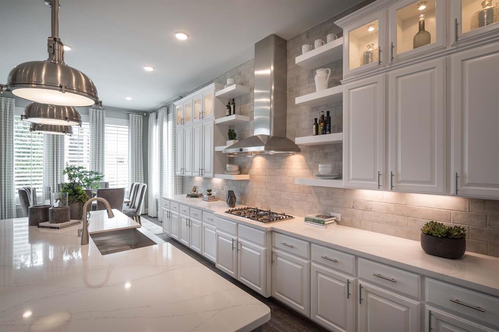 931 Fallkirk Drive Prosper, TX 75078 - Photo 4 of 7 a kitchen with stainless steel appliances granite countertop a stove a sink and a refrigerator