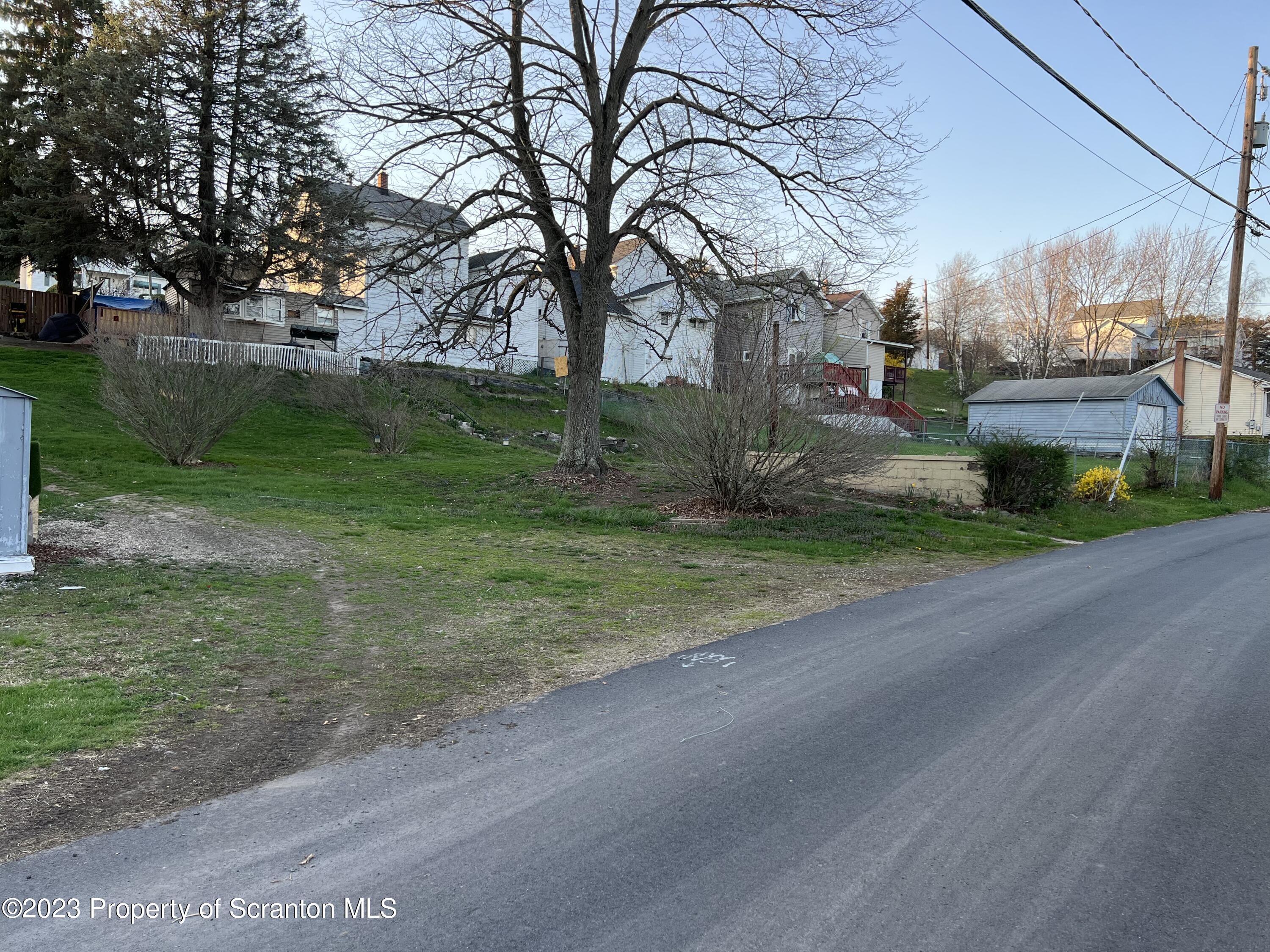 232 238 Main Street Olyphant, PA 18447 - Photo 3 of 3 a view of a house with a big yard and large trees