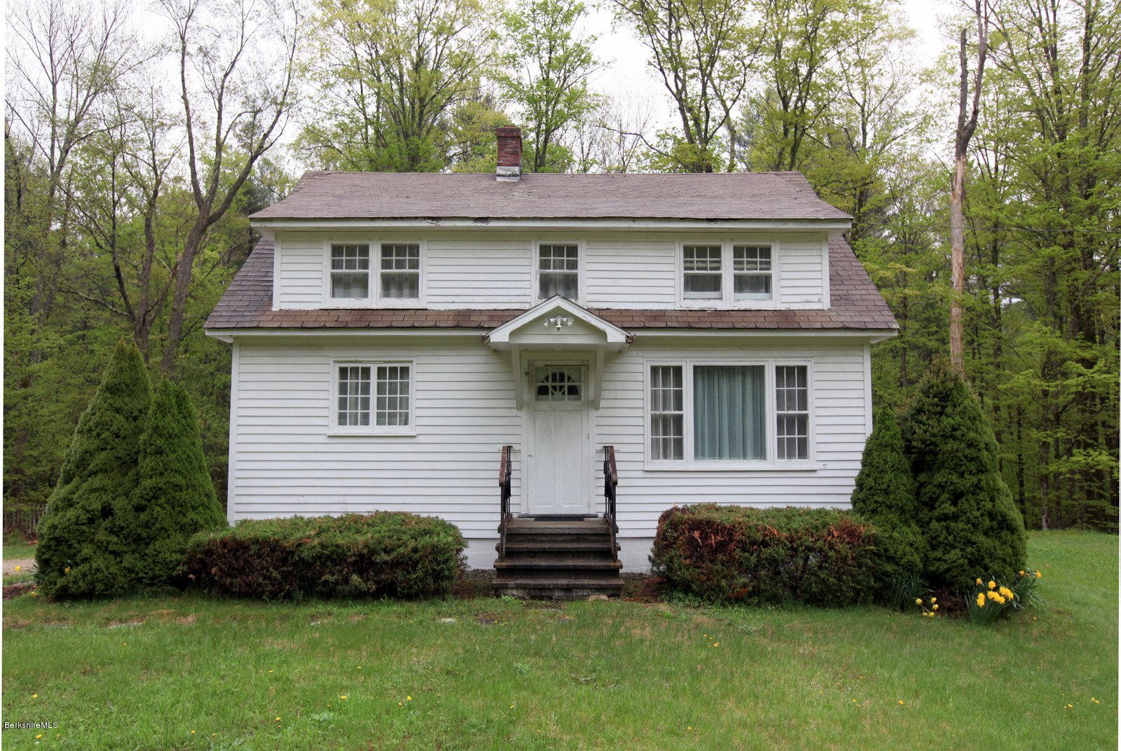 136 Tyringham Road Monterey, MA 01245 - Photo 3 of 27 a front view of a house with a garden